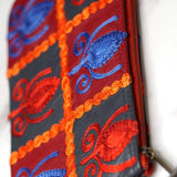 Vibrant colorful purse with kashmiri hand embroidery, has a secure zip top closure, ethically made in Nepal.