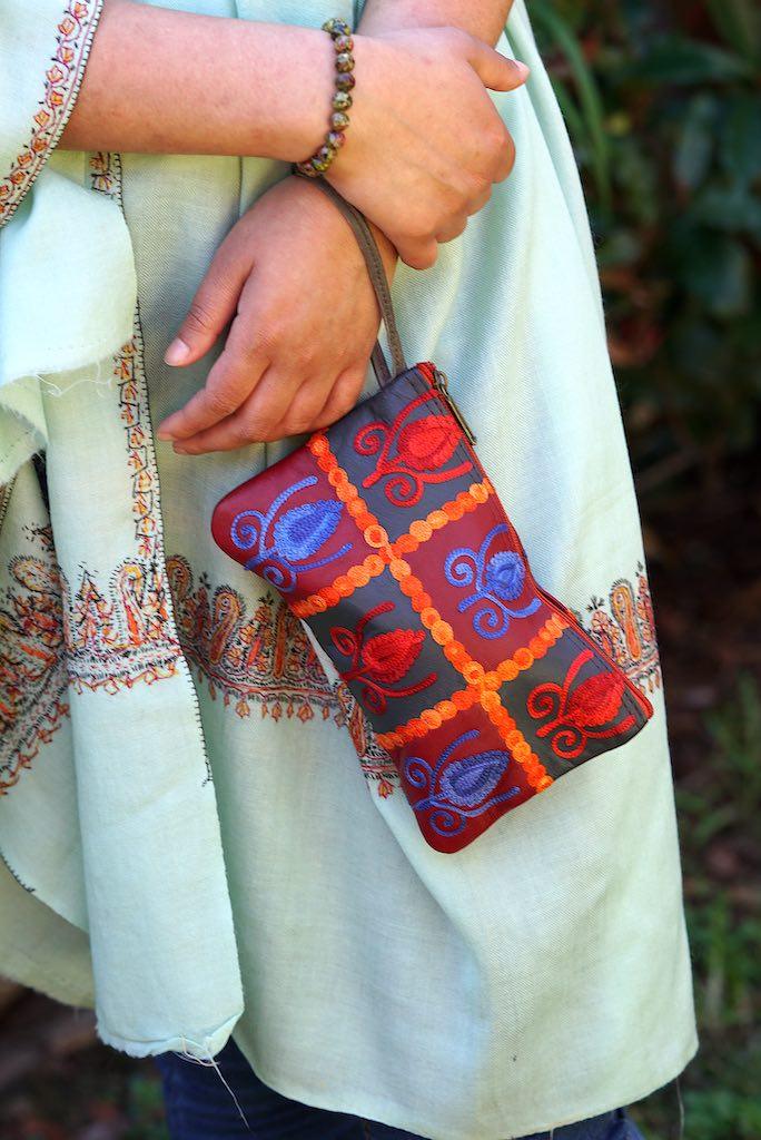 Vibrant colorful purse with kashmiri hand embroidery, has a secure zip top closure, ethically made in Nepal.