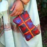 Vibrant colorful purse with kashmiri hand embroidery, has a secure zip top closure, ethically made in Nepal.