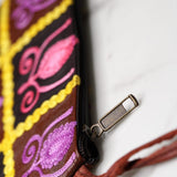 Vibrant colorful purse with kashmiri hand embroidery, has a secure zip top closure, ethically made in Nepal.