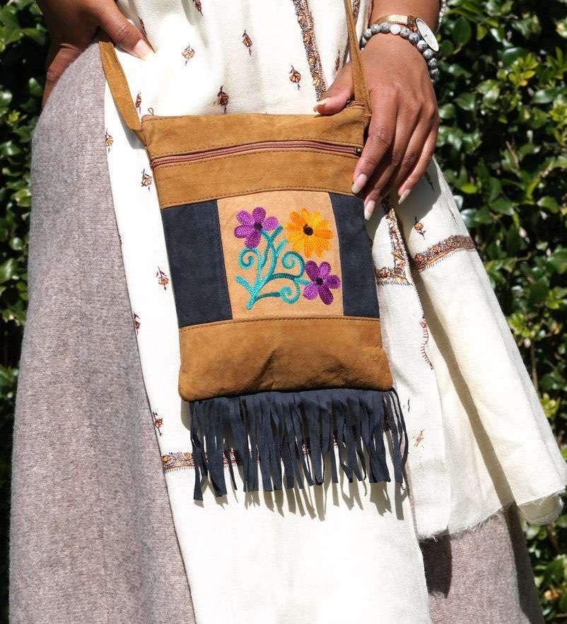 Easy to carry side bag for women, features a beautiful hand embroidered floral pattern.