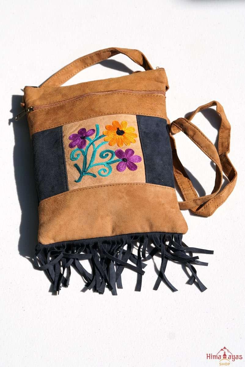 Easy to carry side bag for women, features a beautiful hand embroidered floral pattern.