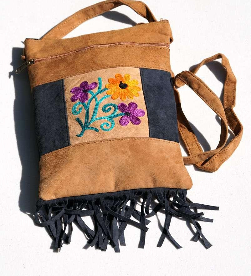 Easy to carry side bag for women, features a beautiful hand embroidered floral pattern.