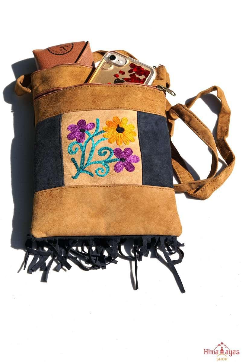 Easy to carry side bag for women, features a beautiful hand embroidered floral pattern.