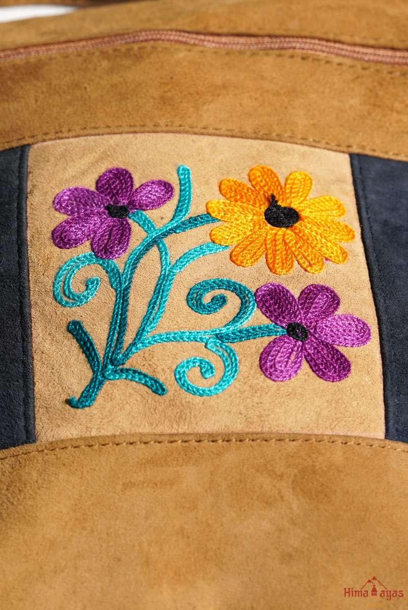 Easy to carry side bag for women, features a beautiful hand embroidered floral pattern.