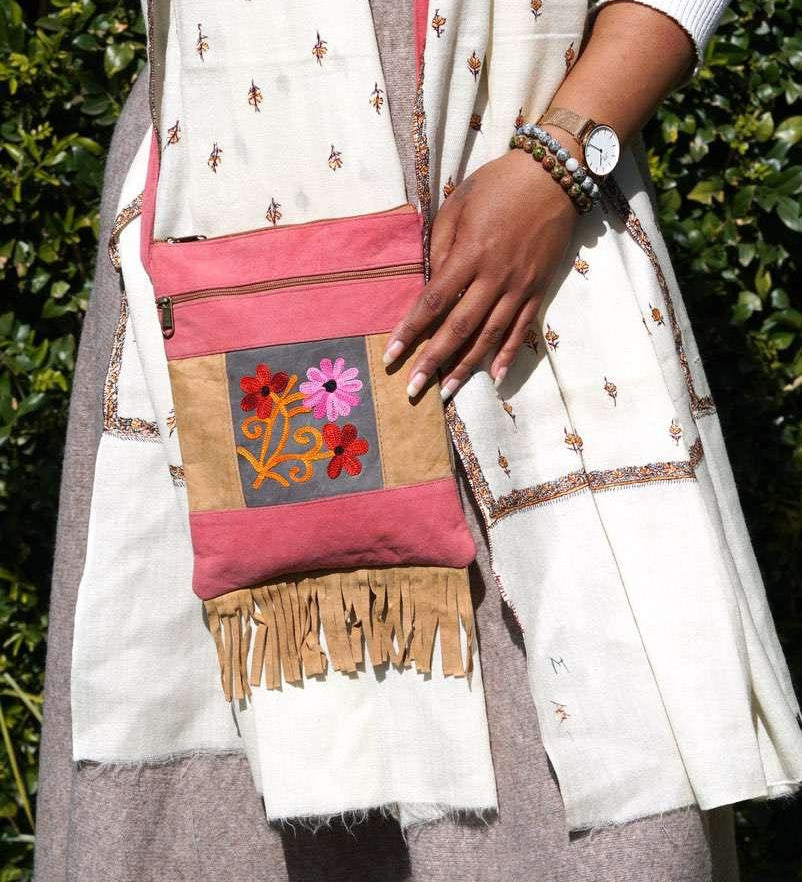 Easy to carry side bag for women, features a beautiful hand embroidered floral pattern.