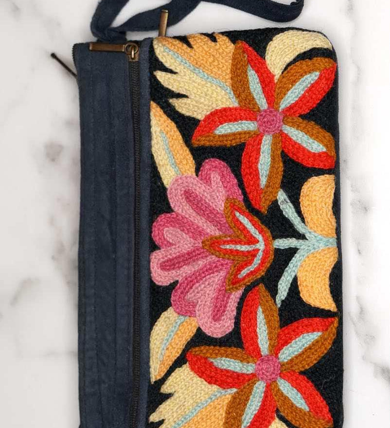 A stylish yet convenient hand woven wristlet purse with beautiful floral pattern, It has a secure zip top closure and two extra compartments for your everyday essentials making it easy to travel simple and light.