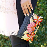 A stylish yet convenient hand woven wristlet purse with beautiful floral pattern, It has a secure zip top closure and two extra compartments for your everyday essentials making it easy to travel simple and light.