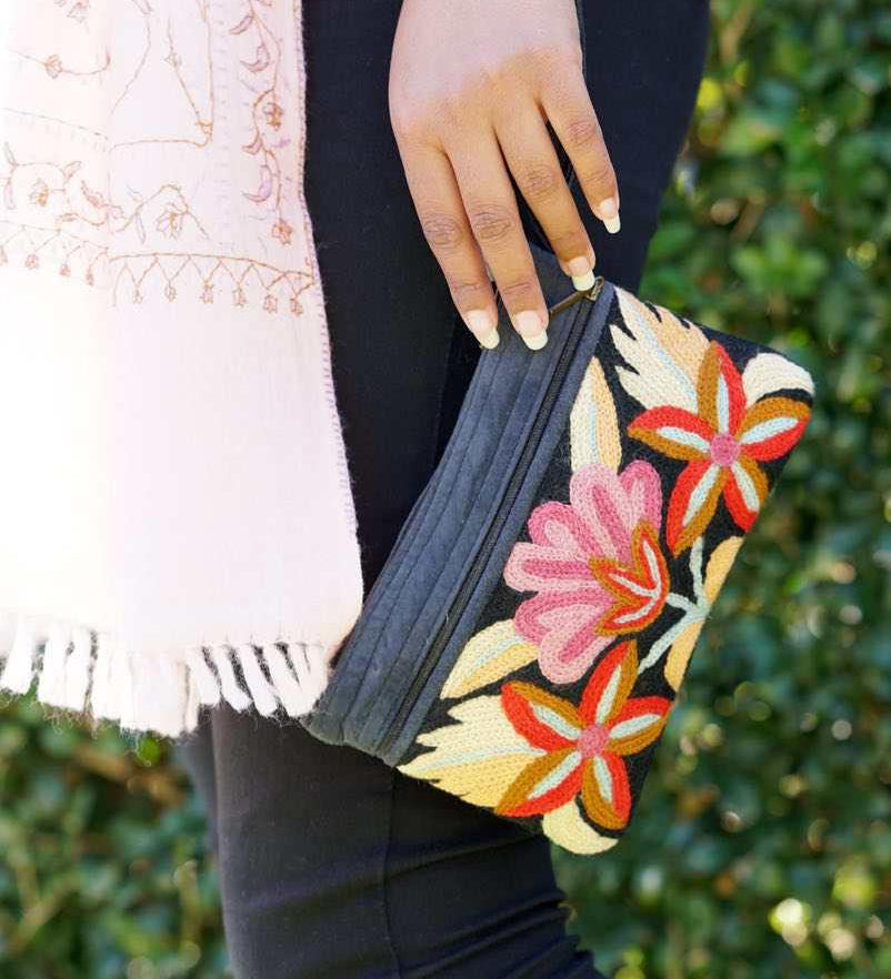 A stylish yet convenient hand woven wristlet purse with beautiful floral pattern, It has a secure zip top closure and two extra compartments for your everyday essentials making it easy to travel simple and light.
