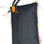 Beautiful flower pattern woman's purse that features a wristlet and secure zip top closure.