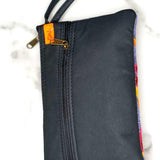 Beautiful flower pattern woman's purse that features a wristlet and secure zip top closure.