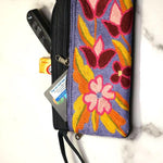 Beautiful flower pattern woman's purse that features a wristlet and secure zip top closure.