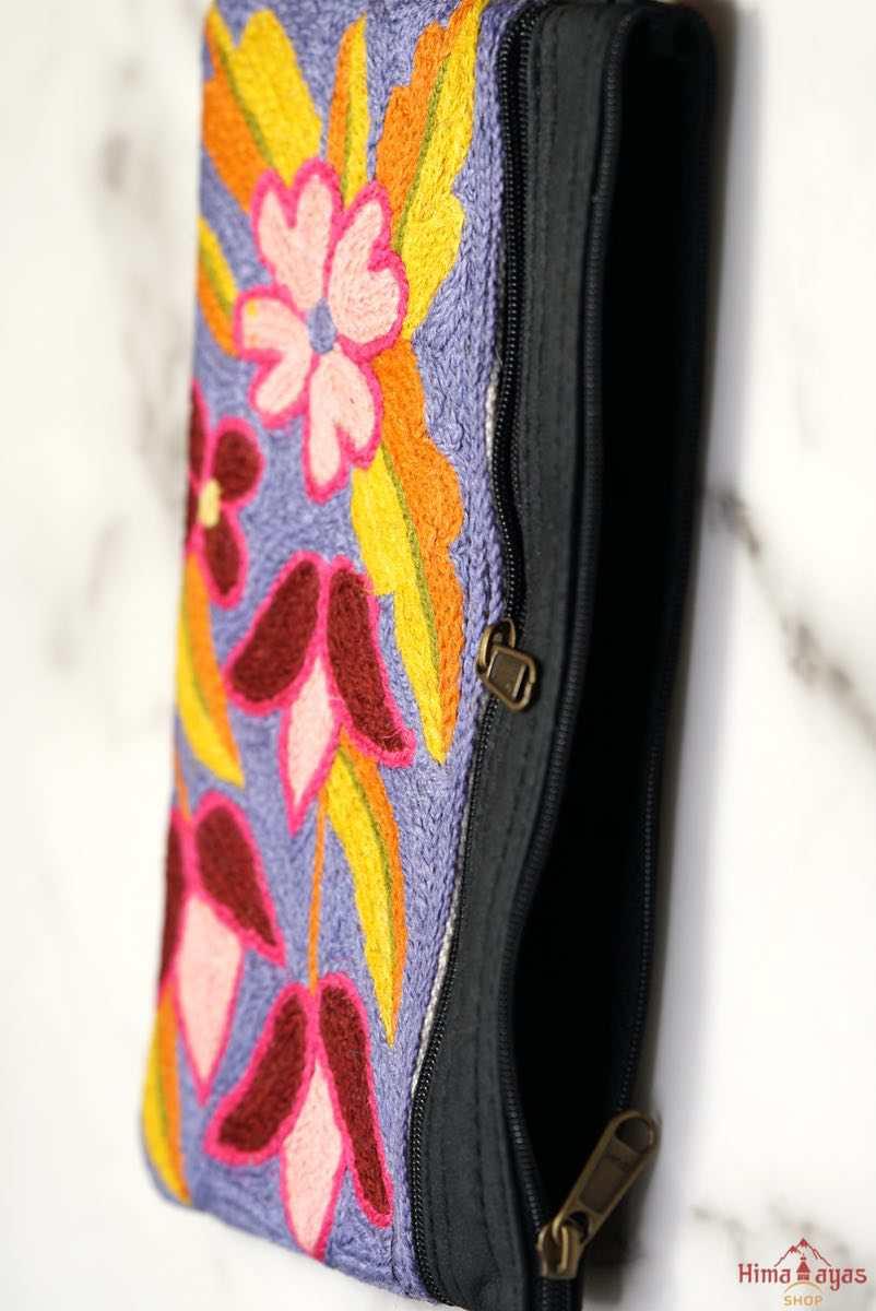 Beautiful flower pattern woman's purse that features a wristlet and secure zip top closure.