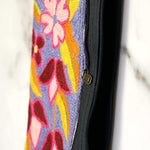 Beautiful flower pattern woman's purse that features a wristlet and secure zip top closure.