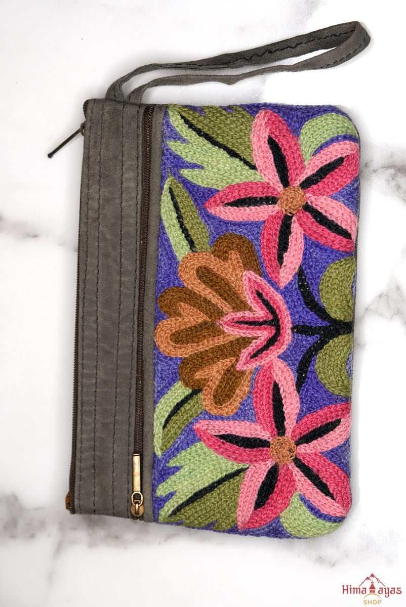A stylish yet convenient hand woven wristlet purse with beautiful floral pattern, It has a secure zip top closure and two extra compartments for your everyday essentials making it easy to travel simple and light.