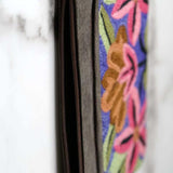 A stylish yet convenient hand woven wristlet purse with beautiful floral pattern, It has a secure zip top closure and two extra compartments for your everyday essentials making it easy to travel simple and light.