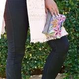 A stylish yet convenient hand woven wristlet purse with beautiful floral pattern, It has a secure zip top closure and two extra compartments for your everyday essentials making it easy to travel simple and light.