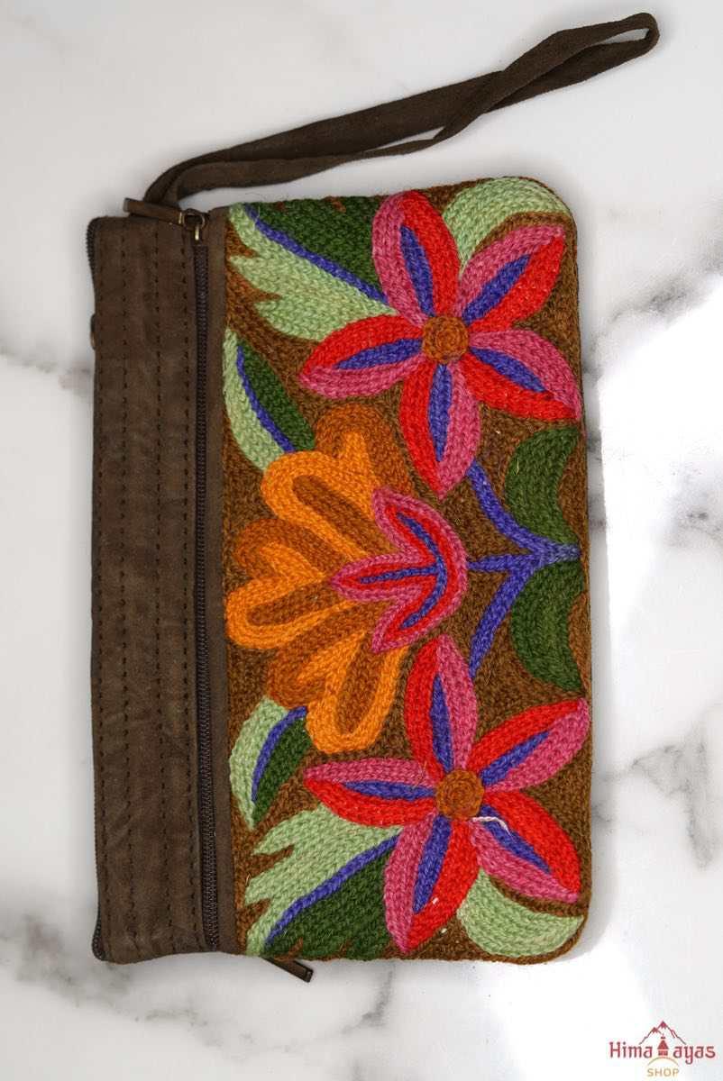 A stylish yet convenient hand woven wristlet purse with beautiful floral pattern, It has a secure zip top closure and two extra compartments for your everyday essentials making it easy to travel simple and light.