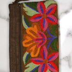 A stylish yet convenient hand woven wristlet purse with beautiful floral pattern, It has a secure zip top closure and two extra compartments for your everyday essentials making it easy to travel simple and light.