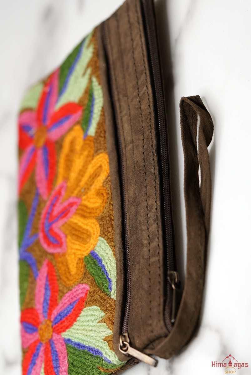 A stylish yet convenient hand woven wristlet purse with beautiful floral pattern, It has a secure zip top closure and two extra compartments for your everyday essentials making it easy to travel simple and light.