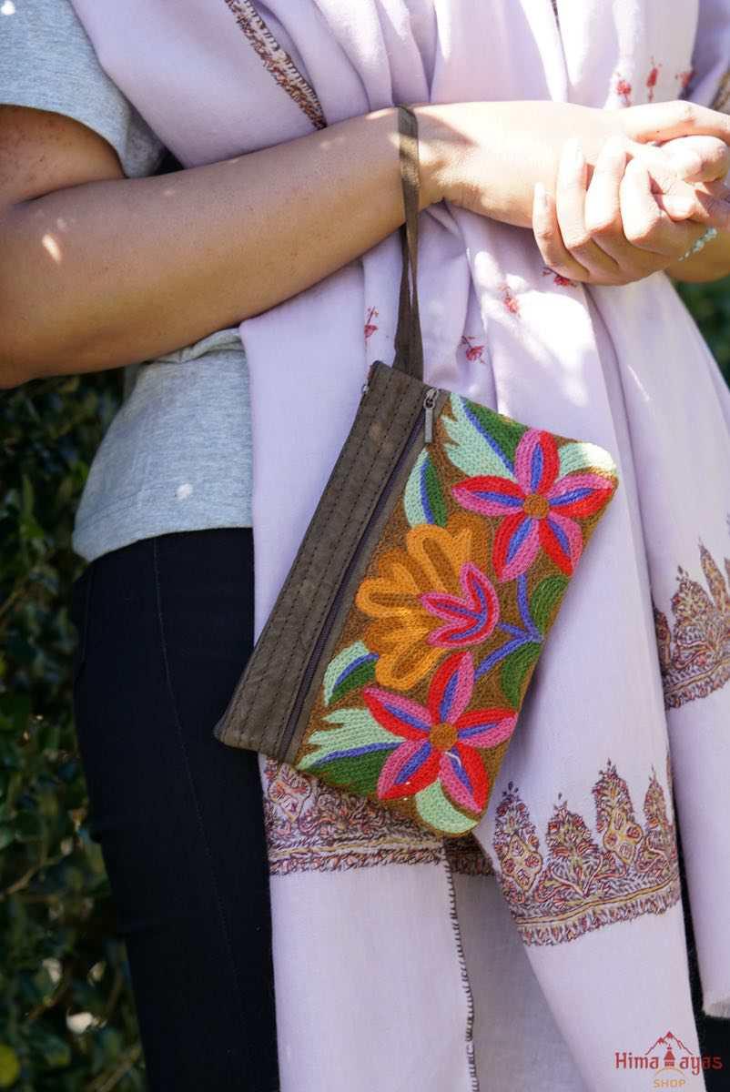 A stylish yet convenient hand woven wristlet purse with beautiful floral pattern, It has a secure zip top closure and two extra compartments for your everyday essentials making it easy to travel simple and light.