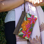A stylish yet convenient hand woven wristlet purse with beautiful floral pattern, It has a secure zip top closure and two extra compartments for your everyday essentials making it easy to travel simple and light.