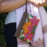 A stylish yet convenient hand woven wristlet purse with beautiful floral pattern, It has a secure zip top closure and two extra compartments for your everyday essentials making it easy to travel simple and light.