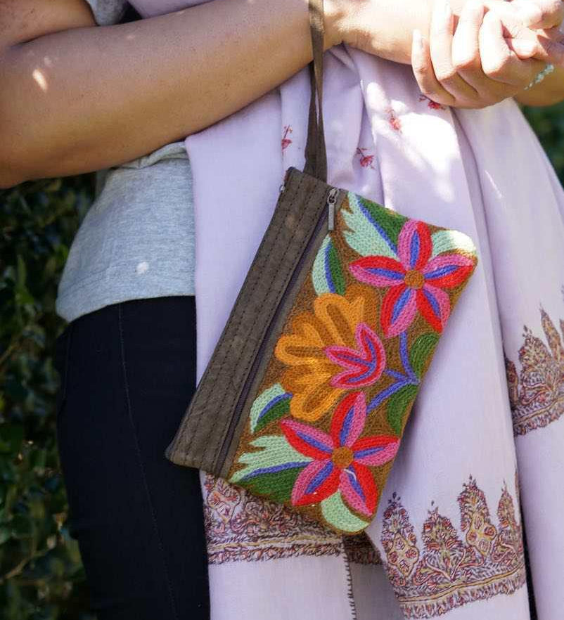 A stylish yet convenient hand woven wristlet purse with beautiful floral pattern, It has a secure zip top closure and two extra compartments for your everyday essentials making it easy to travel simple and light.