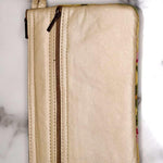 A stylish yet convenient hand woven wristlet purse with beautiful floral pattern, It has a secure zip top closure and two extra compartments for your everyday essentials making it easy to travel simple and light.