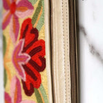 A stylish yet convenient hand woven wristlet purse with beautiful floral pattern, It has a secure zip top closure and two extra compartments for your everyday essentials making it easy to travel simple and light.