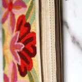 A stylish yet convenient hand woven wristlet purse with beautiful floral pattern, It has a secure zip top closure and two extra compartments for your everyday essentials making it easy to travel simple and light.