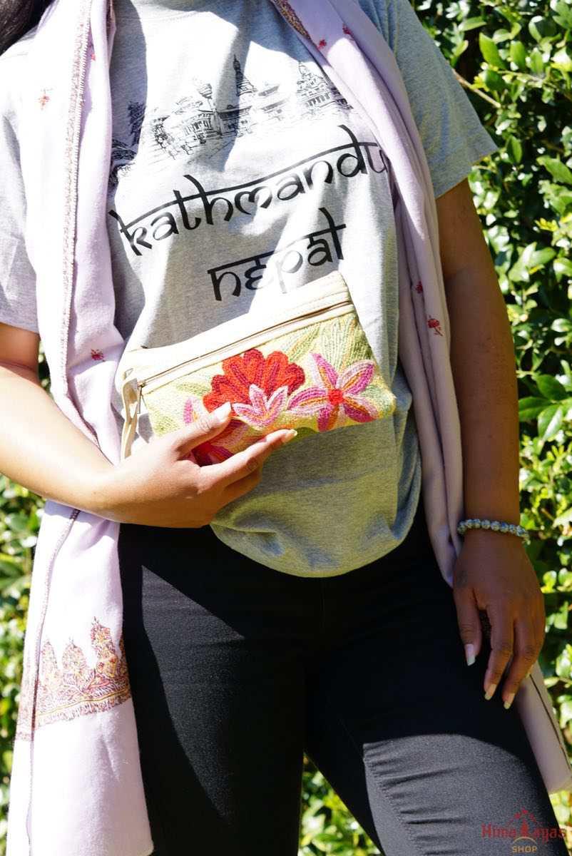 A stylish yet convenient hand woven wristlet purse with beautiful floral pattern, It has a secure zip top closure and two extra compartments for your everyday essentials making it easy to travel simple and light.