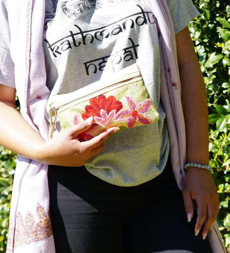 A stylish yet convenient hand woven wristlet purse with beautiful floral pattern, It has a secure zip top closure and two extra compartments for your everyday essentials making it easy to travel simple and light.