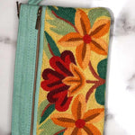 A stylish yet convenient hand woven wristlet purse with beautiful floral pattern, It has a secure zip top closure and two extra compartments for your everyday essentials making it easy to travel simple and light.