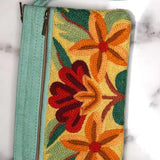 A stylish yet convenient hand woven wristlet purse with beautiful floral pattern, It has a secure zip top closure and two extra compartments for your everyday essentials making it easy to travel simple and light.