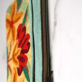 A stylish yet convenient hand woven wristlet purse with beautiful floral pattern, It has a secure zip top closure and two extra compartments for your everyday essentials making it easy to travel simple and light.