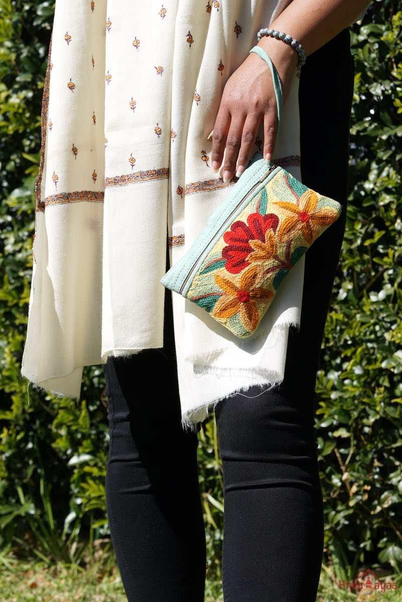 A stylish yet convenient hand woven wristlet purse with beautiful floral pattern, It has a secure zip top closure and two extra compartments for your everyday essentials making it easy to travel simple and light.