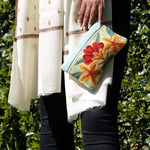 A stylish yet convenient hand woven wristlet purse with beautiful floral pattern, It has a secure zip top closure and two extra compartments for your everyday essentials making it easy to travel simple and light.