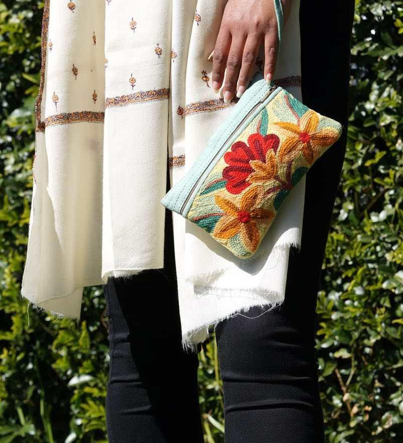 A stylish yet convenient hand woven wristlet purse with beautiful floral pattern, It has a secure zip top closure and two extra compartments for your everyday essentials making it easy to travel simple and light.