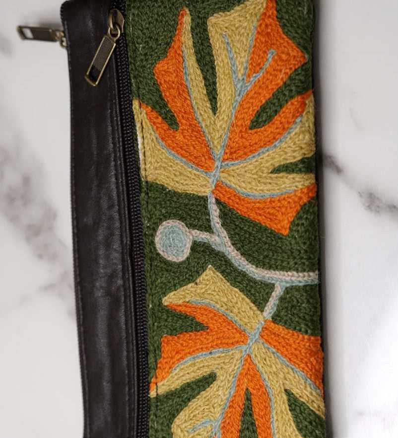 A beautifully hand-embroidered purse with a wristlet and a secure zip top closure. Perfect gift for your loved ones!