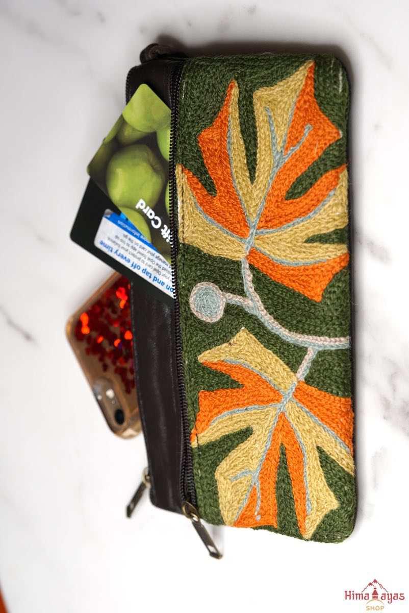 A beautifully hand-embroidered purse with a wristlet and a secure zip top closure. Perfect gift for your loved ones!