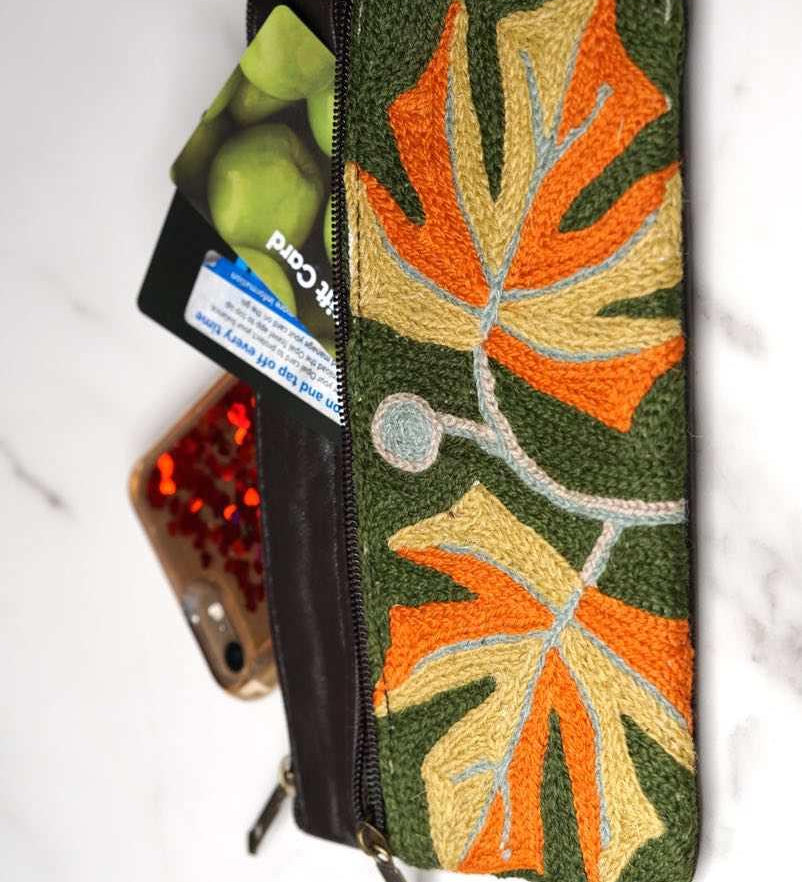 A beautifully hand-embroidered purse with a wristlet and a secure zip top closure. Perfect gift for your loved ones!