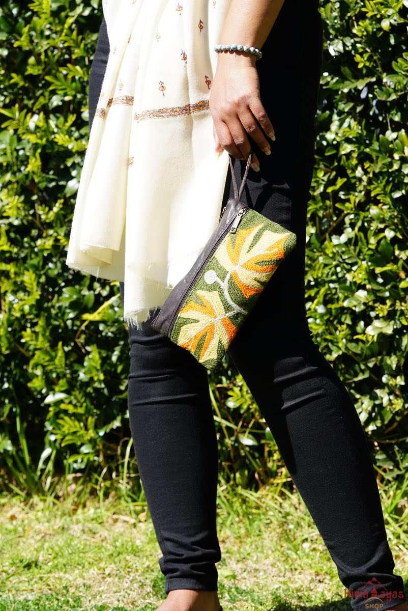 A beautifully hand-embroidered purse with a wristlet and a secure zip top closure. Perfect gift for your loved ones!