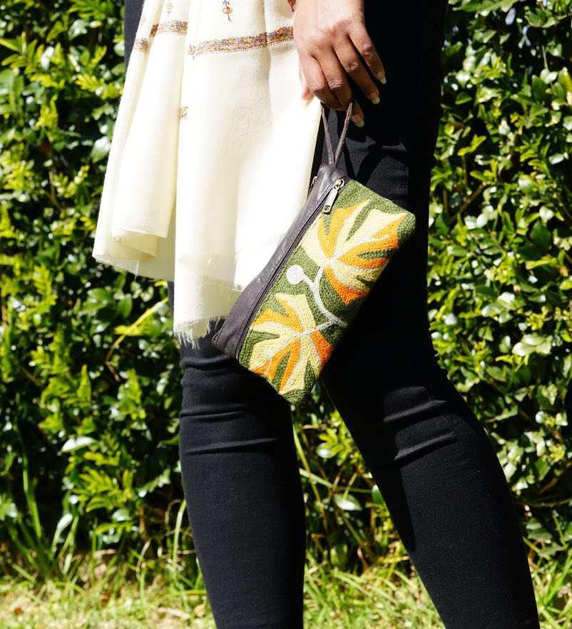 A beautifully hand-embroidered purse with a wristlet and a secure zip top closure. Perfect gift for your loved ones!