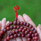 Rosewood Mala being held