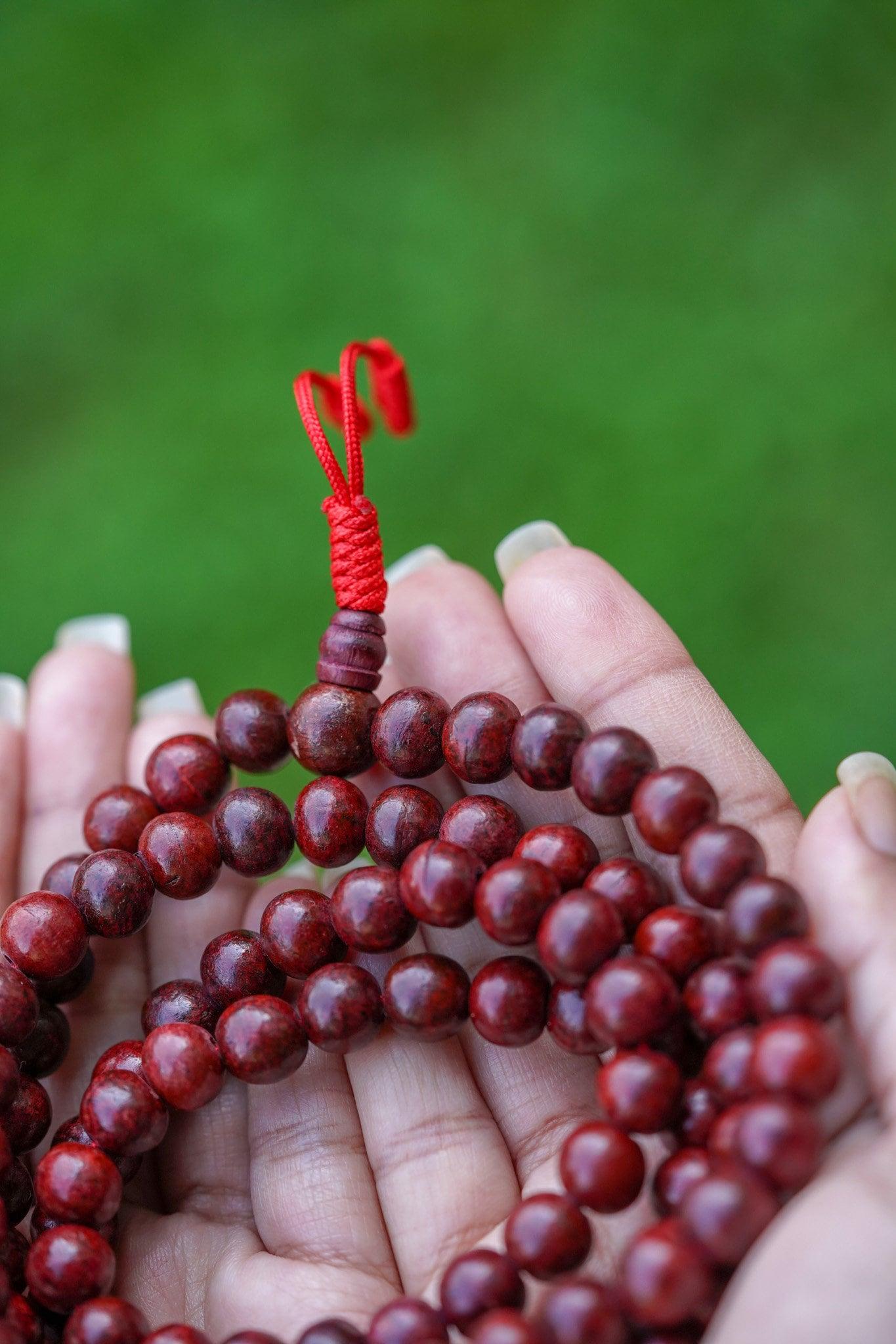 Rosewood Mala being held