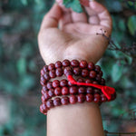 Rosewood Mala being worn around wrist