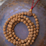 Rudraksha Bead Mala on top of a bowl