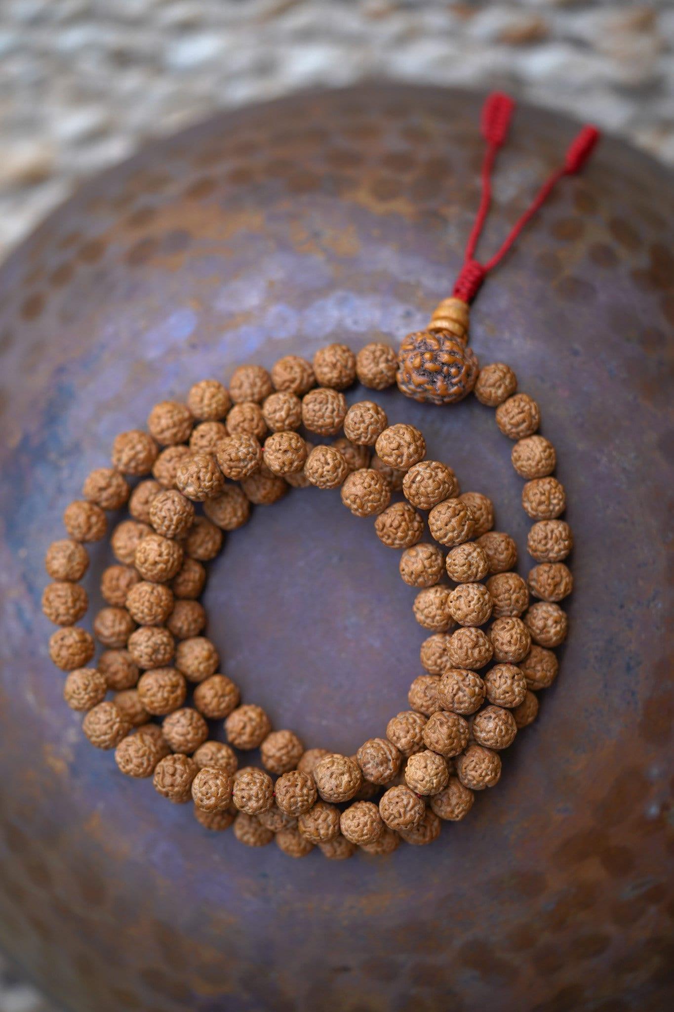 Rudraksha Bead Mala on top of a bowl