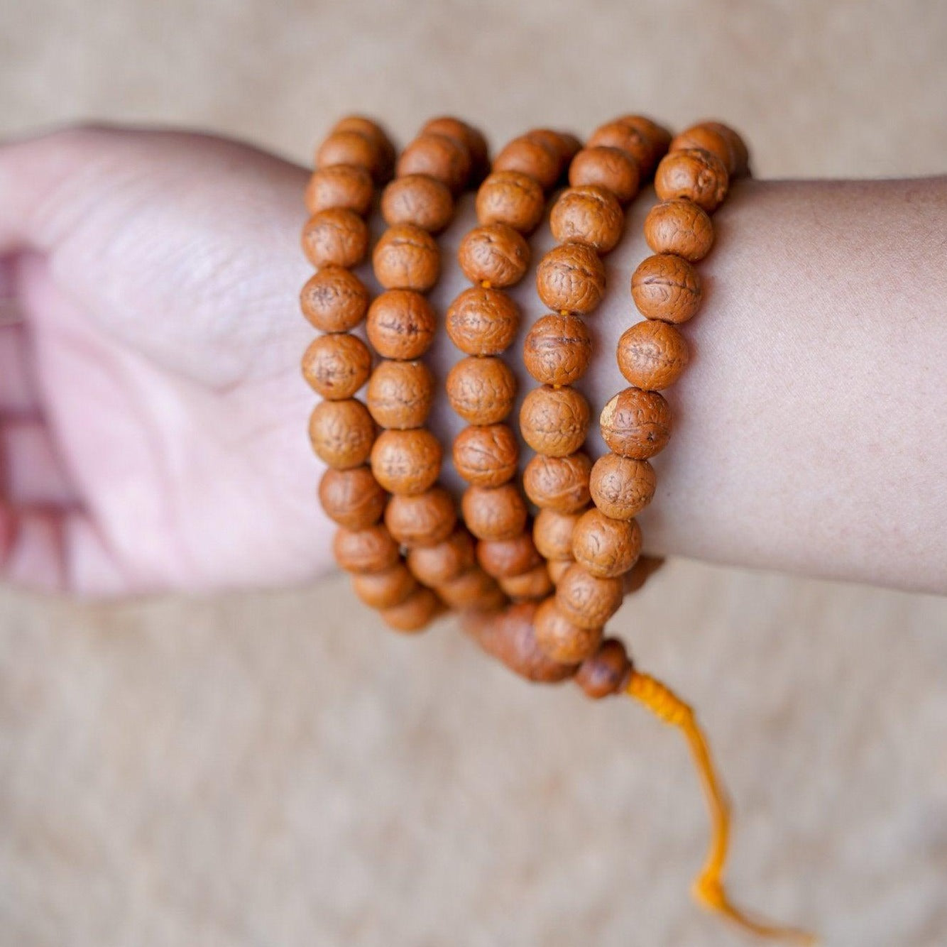 High Quality Bodhi Mala being worn around wrist aerial view